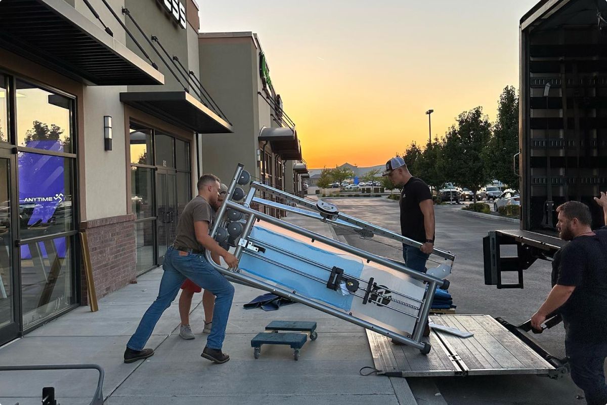 Express Gym Supply experts unloading a piece of equipment from a truck