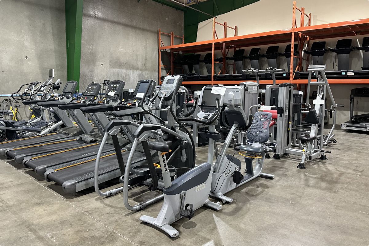 The warehouse at Express Gym Supply featuring different pieces of cardio equipment