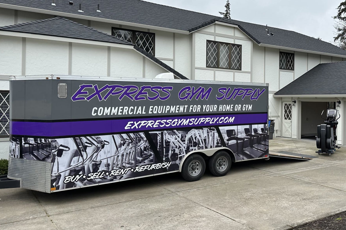 Express Gym Supply truck delivering a stair stepper