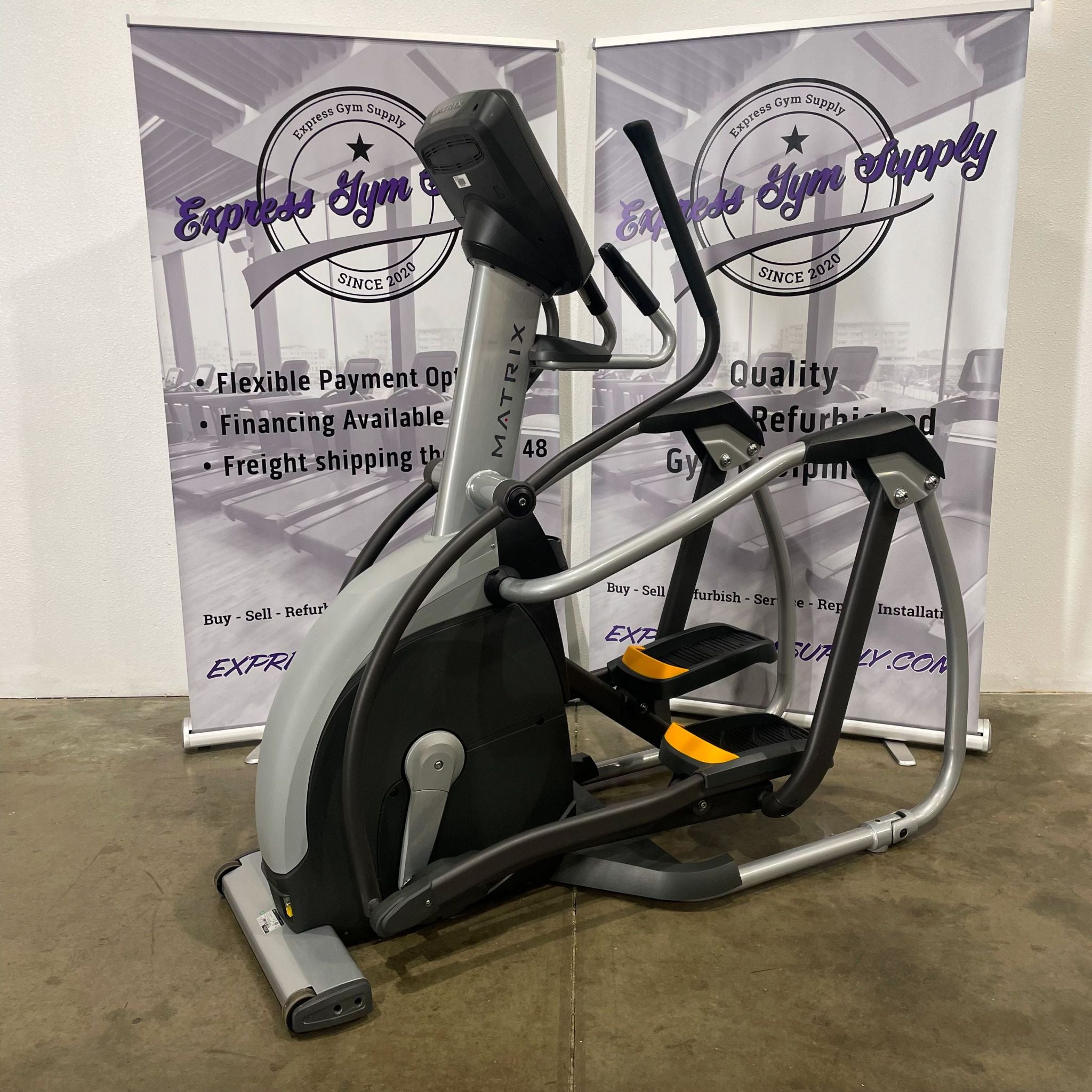 Back right view of the Matrix E1x Elliptical in Warehouse