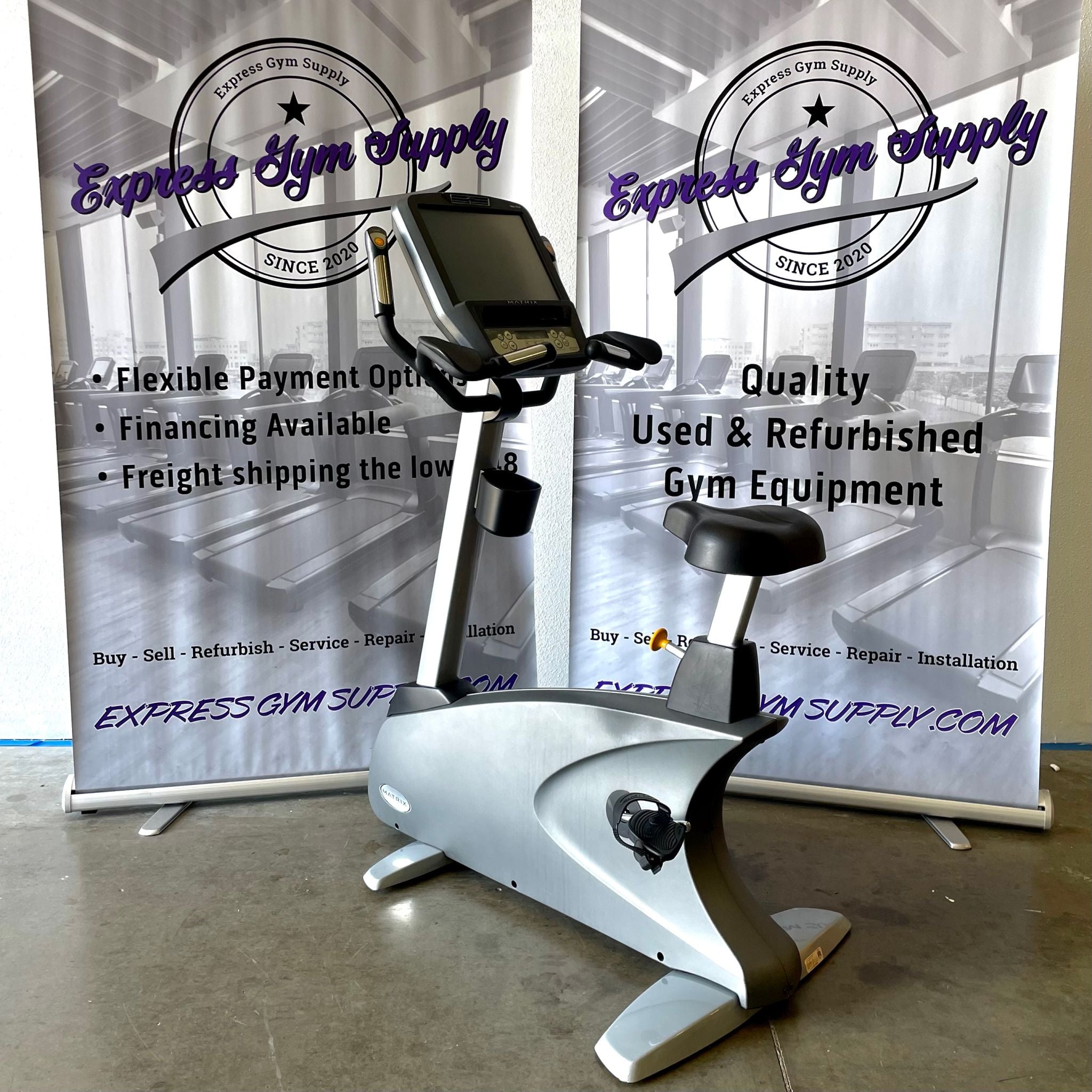 Front left-hand view of the Matrix U7x Upright Exercise Bike in Warehouse