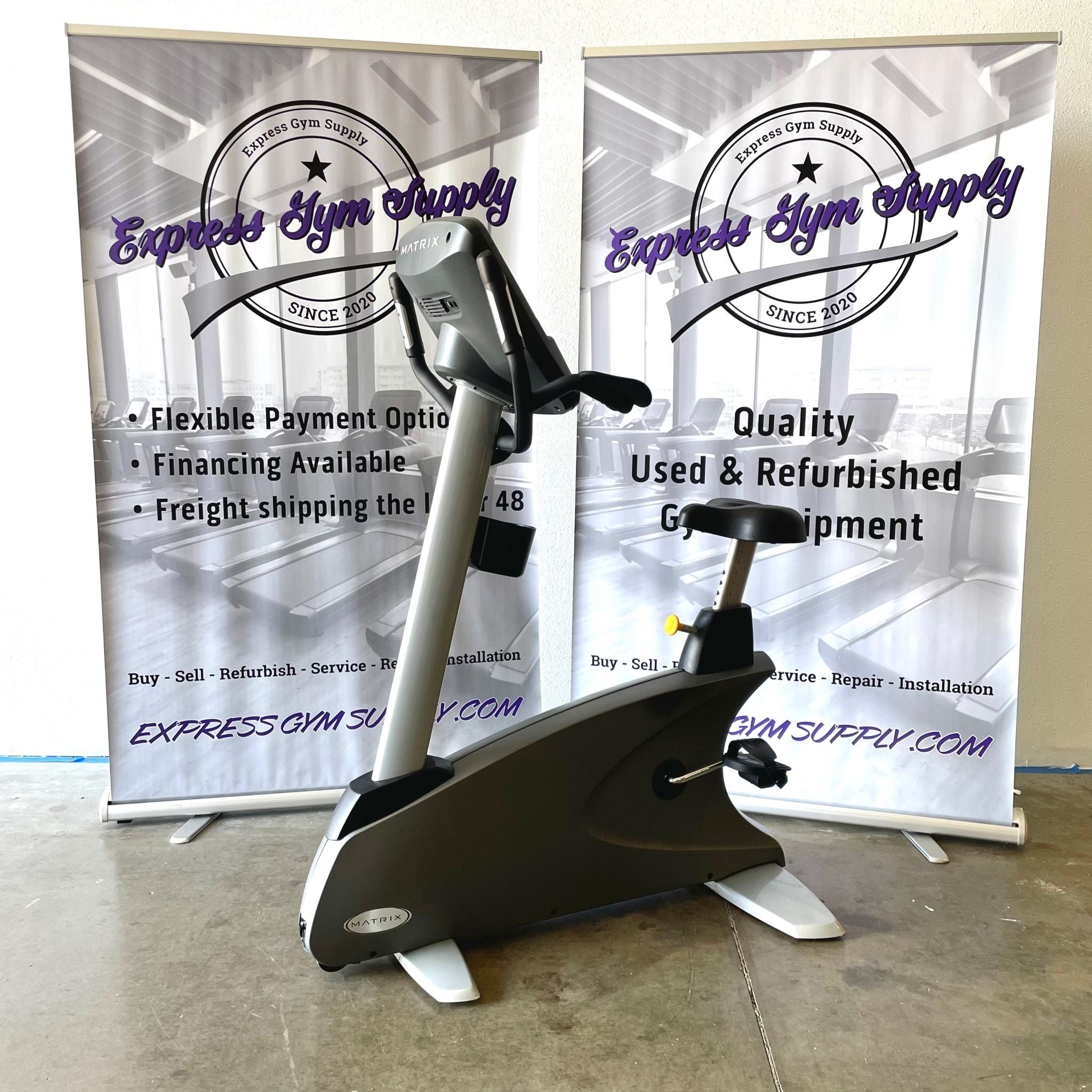 Back left-hand view of the Matrix U7x Upright Exercise Bike in Warehouse